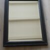 Oude spiegel zwart houten lijst
